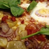 Pizza with spinach, potato slices and red onion